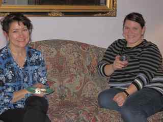 The two hostesses sitting on a couch.