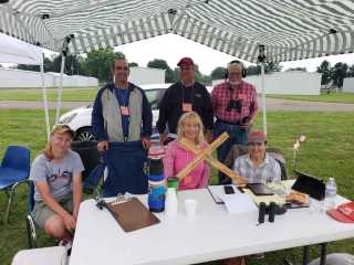 Air-Race judges and timers at a table under shade-tent at Newark-Heath airport.