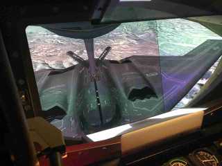 Boom-operator's training-simulator view of a B-2 bomber taking fuel from a tanker